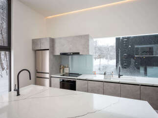 Modern kitchen with sleek countertops and integrated appliances.