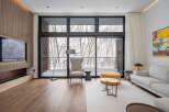 This stunning property boasts floor-to-ceiling windows offering breathtaking views of a snow-covered landscape.