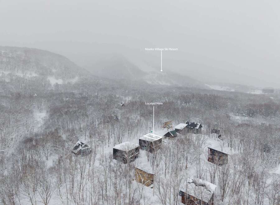 Nestled in a snowy forest, this charming house offers a serene escape.