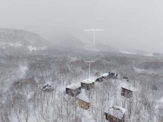 Nestled in a snowy forest, this charming house offers a serene escape.