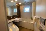 This modern bathroom boasts a sleek design with a bathtub, toilet, and sink.