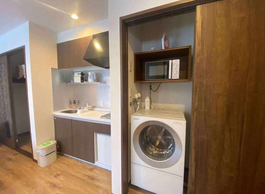 This cozy apartment boasts a modern kitchenette complete with a microwave, kettle, and coffee maker.