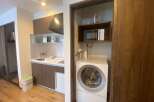 This cozy apartment boasts a modern kitchenette complete with a microwave, kettle, and coffee maker.
