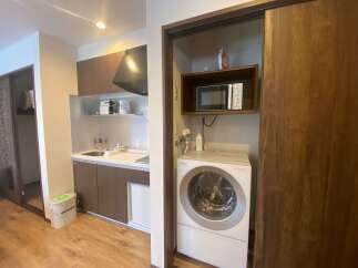 This cozy apartment boasts a modern kitchenette complete with a microwave, kettle, and coffee maker.
