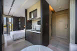 This modern hotel room boasts a stylish kitchenette, perfect for a comfortable stay.