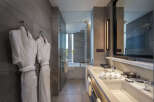 Luxurious bathroom with double sinks, a soaking tub, and a walk-in shower.
