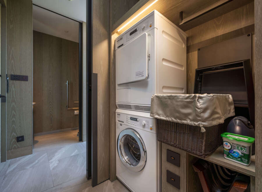 This luxurious property boasts a modern laundry closet complete with Miele washer and dryer, conveniently tucked away for ultimate convenience.