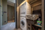 This luxurious property boasts a modern laundry closet complete with Miele washer and dryer, conveniently tucked away for ultimate convenience.
