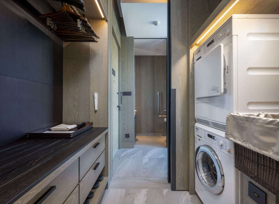 Luxury condo with modern laundry facilities featuring a washer and dryer.