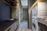 Luxury condo with modern laundry facilities featuring a washer and dryer.
