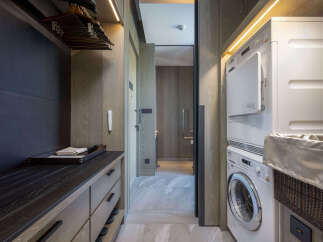 Luxury condo with modern laundry facilities featuring a washer and dryer.