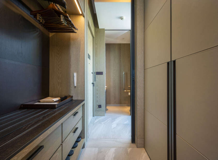 Luxury hotel room with spacious walk-in closet and built-in dresser.