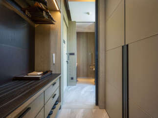 Luxury hotel room with spacious walk-in closet and built-in dresser.