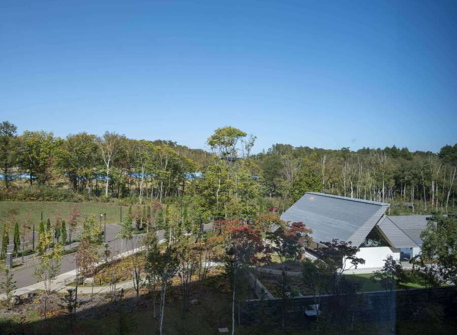 Nestled amidst a vibrant autumn landscape, this property boasts a unique architectural design with a modern, angular building.