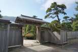 Discover serenity at this exquisite property, featuring a traditional Japanese gate and meticulously landscaped gardens.