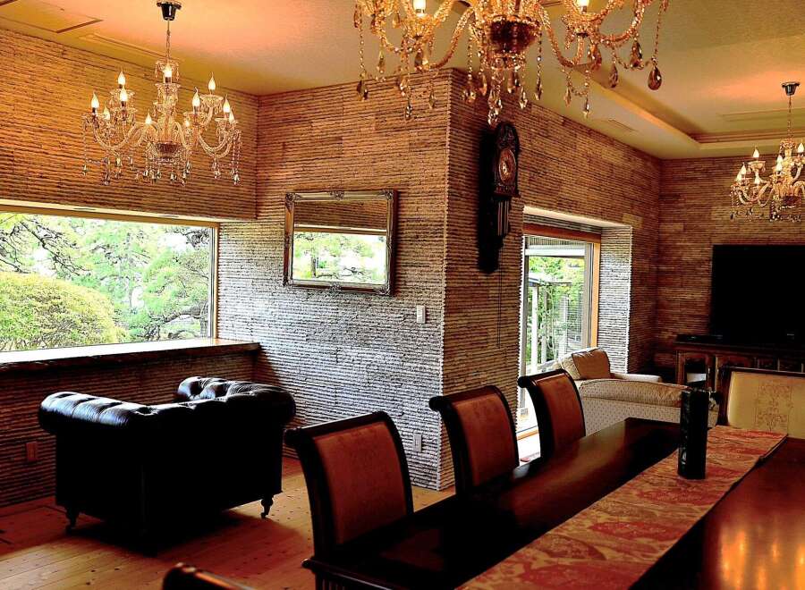 Luxurious living room with stunning stone wall accents and large windows offering scenic views.
