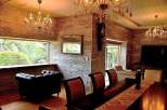 Luxurious living room with stunning stone wall accents and large windows offering scenic views.
