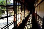 This stunning Japanese-style hallway boasts floor-to-ceiling windows offering breathtaking garden views.