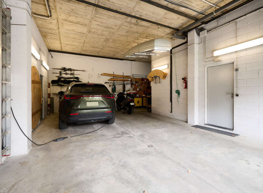 This spacious garage offers ample room for parking a car and storing various items.