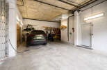 This spacious garage offers ample room for parking a car and storing various items.