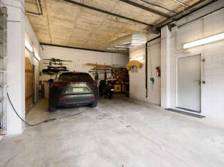 This spacious garage offers ample room for parking a car and storing various items.
