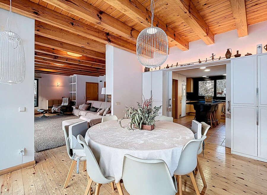 Experience the charm of this stunning property, featuring a beautifully designed dining area with a round table and modern chairs.