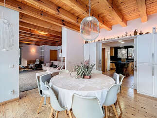 Experience the charm of this stunning property, featuring a beautifully designed dining area with a round table and modern chairs.