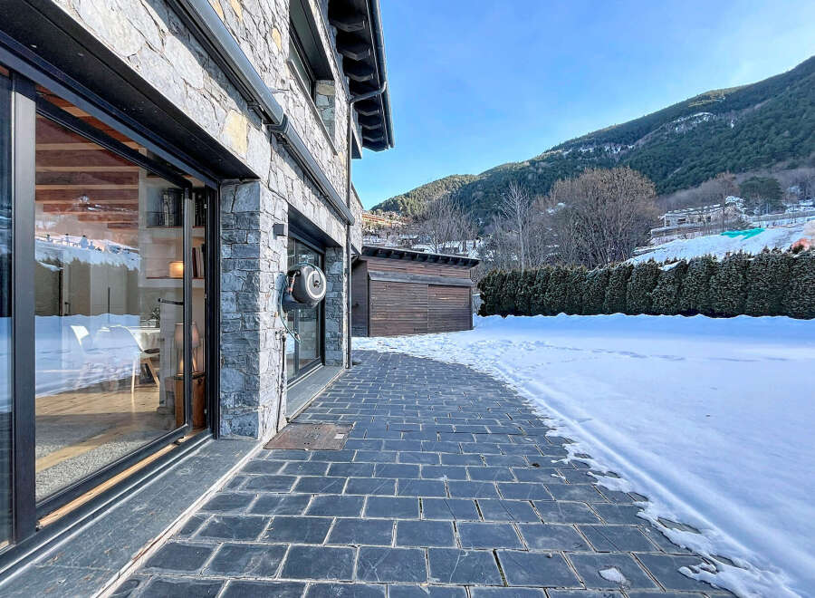 This stunning property boasts a modern design with a beautiful stone facade, offering a luxurious and inviting atmosphere.