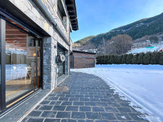 This stunning property boasts a modern design with a beautiful stone facade, offering a luxurious and inviting atmosphere.