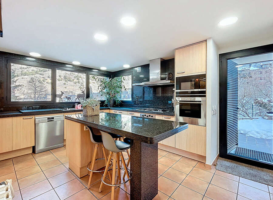 This stunning kitchen boasts a modern design with sleek granite countertops and stainless steel appliances.