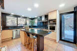 This stunning kitchen boasts a modern design with sleek granite countertops and stainless steel appliances.
