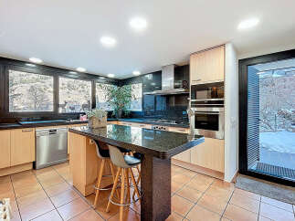 This stunning kitchen boasts a modern design with sleek granite countertops and stainless steel appliances.