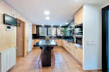 This stunning kitchen boasts a modern design with sleek cabinetry and a spacious island, perfect for culinary enthusiasts.