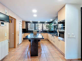 This stunning kitchen boasts a modern design with sleek cabinetry and a spacious island, perfect for culinary enthusiasts.