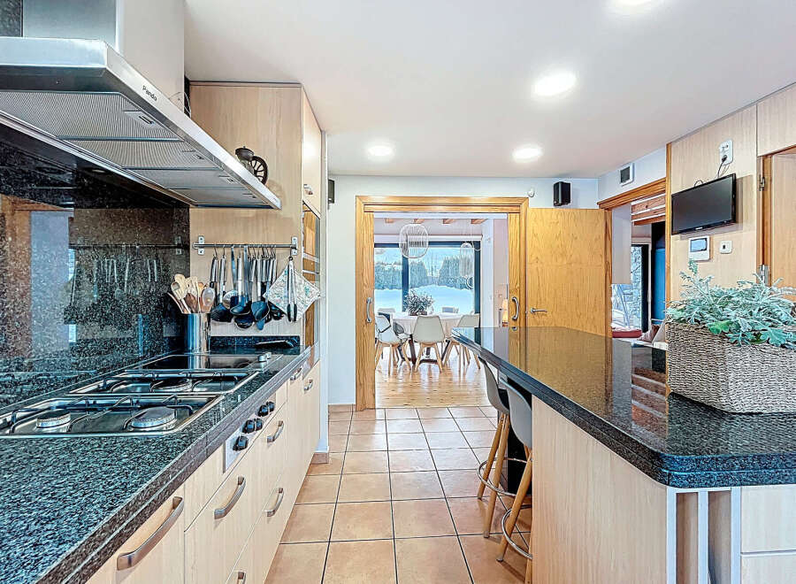 This stunning kitchen boasts a sleek, modern design with granite countertops and stainless steel appliances.