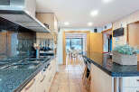 This stunning kitchen boasts a sleek, modern design with granite countertops and stainless steel appliances.