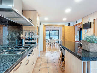 This stunning kitchen boasts a sleek, modern design with granite countertops and stainless steel appliances.