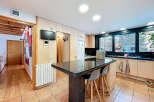 This stunning kitchen boasts a modern design with a sleek granite countertop island, perfect for entertaining.