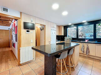 This stunning kitchen boasts a modern design with a sleek granite countertop island, perfect for entertaining.