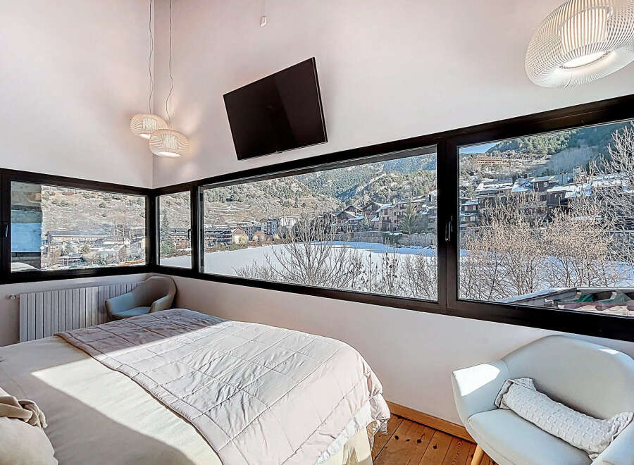 Experience breathtaking mountain views from this stunning bedroom.