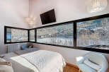 Experience breathtaking mountain views from this stunning bedroom.