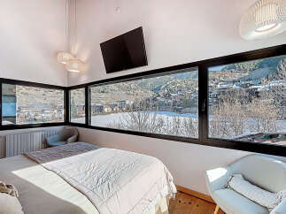 Experience breathtaking mountain views from this stunning bedroom.