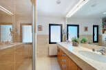 This luxurious bathroom boasts a sleek design with a double vanity and ample counter space.