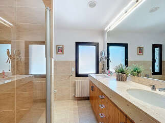 This luxurious bathroom boasts a sleek design with a double vanity and ample counter space.