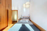 This cozy bedroom features a comfortable bed with soft bedding, perfect for a relaxing retreat.