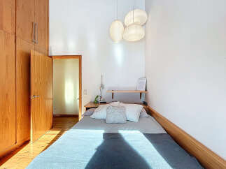 This cozy bedroom features a comfortable bed with soft bedding, perfect for a relaxing retreat.