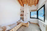 This charming bedroom features a cozy design with wooden accents and a bright, airy feel.