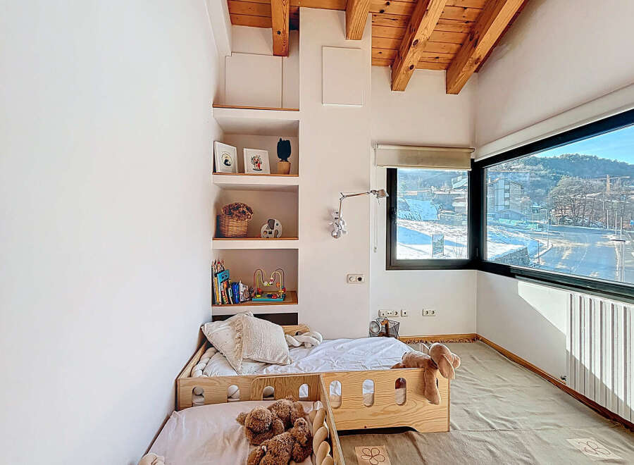 This cozy bedroom features a unique built-in shelving unit, perfect for displaying decor and books.