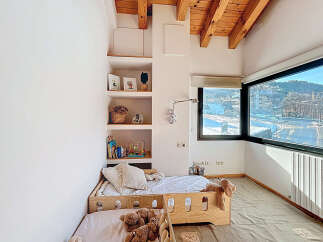 This cozy bedroom features a unique built-in shelving unit, perfect for displaying decor and books.