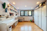 This bright and airy room offers a versatile space, perfect for a home office or creative studio.